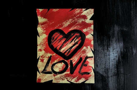 LOVE word handwritten in abstract free style, black backgroundの写真素材