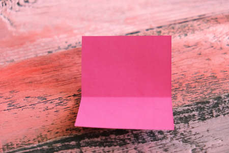 Blank pink paper card on old wooden table. Blank invitation greetings card. mockup. space for text