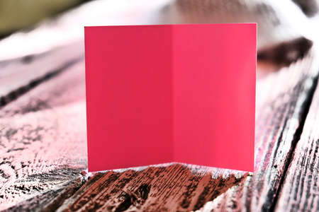 Soft focus of pink note card on pink wooden background, close-up. Cozy, soft, minimal. Love and holiday conceptの写真素材