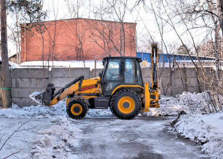 Snow removal equipment, bulldozer machine, cleaning of melted snow, Springtime