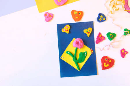 Homemade greeting card, flower and hearts from paper and clay, plasticine as gift for Mothers day,...