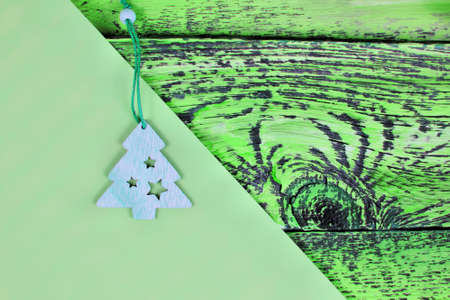 carved wooden christmas tree on green background. Beautiful background for festive holiday. copy space. minimalisticの写真素材
