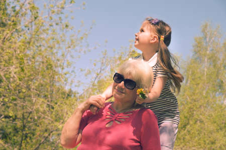 Loving cute granddaughter hugging her grandmother. Happy family.  Having good times with grandparent...