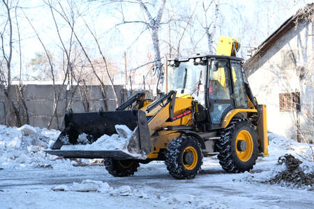 Snow removal equipment, bulldozer machine, cleaning of melted snow, Springtime