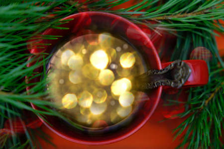 Cup with beautiful Christmas lights of bokeh inside. Christmas minimal still life, copy spaceの写真素材