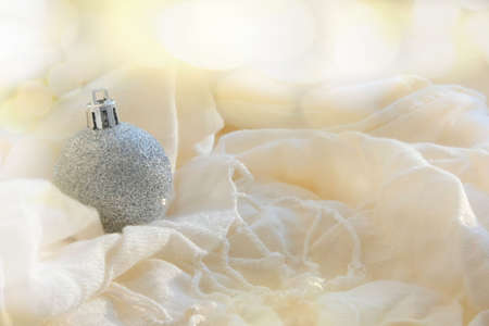 Partial blurred Festively Decorated christmas shiny ball on folded fluffy blanket, bokeh effect, winter moodの写真素材