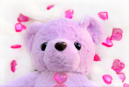 Cute teddy bear with hearts on white fluffy blanket. Valentines day and love conceptの写真素材