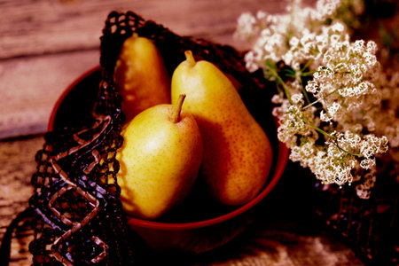 Still life with bowl with sweet pears, autumn atmosphere mood, flowers and fruitsの写真素材