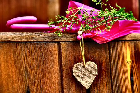 Autumn still life with high contrast and effect grain texture. Pink umbrella, flower and heart. In the partial shade. old fashioned rustic styleの写真素材