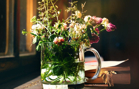 Cup with summer meadow flowers, concept of home comfort, retro atmosphere. Vintage and retro styled. romantic morningの写真素材