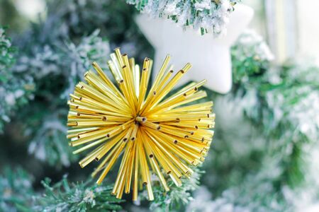ball of metal sticks on the branch of the Christmas tree.の写真素材