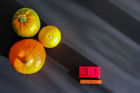 pumpkins and cubes with the inscription October 31 on a black background with shadows. space for text, top viewの写真素材