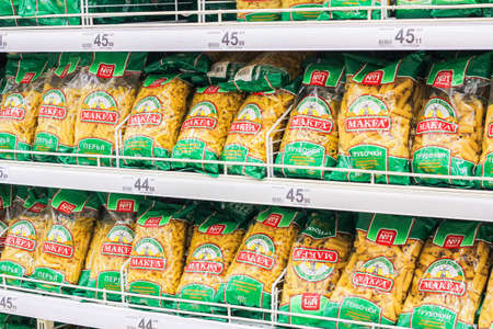 macaroni on the shelves of grocery stores. purchasing products before the crisis. Shopping in a...
