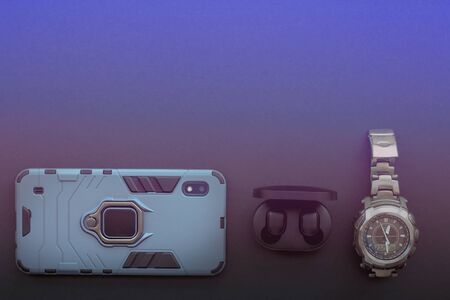 St. Petersburg February 2020: men's dial phone, wireless black headphones and watches.