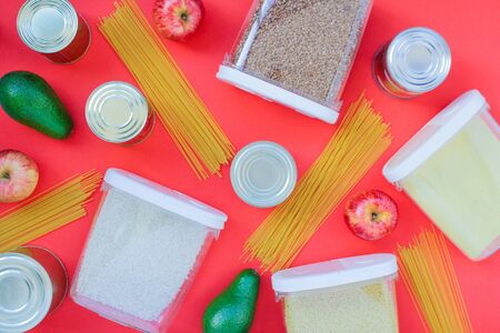 food donation buckwheat, pasta, canned food, avocado, apple. concept Set of quarantine food, red...
