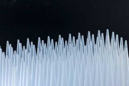 plastic tips for dispensers. Macro of some pipette plastic tips in a rack.の写真素材