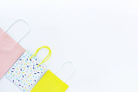 three multi-colored gift bags on a white background. concept of gifts, purchases and holidays