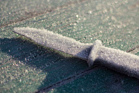the knife is covered with frost. the first frost in the fall. autumn natural background, selective focusの写真素材