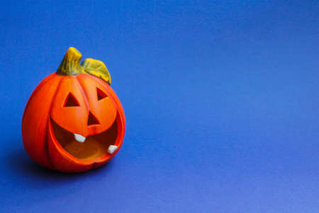 bright orange pumpkin lantern on a blue background. the concept of Halloween.の写真素材