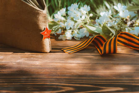 9 may, holiday Victory Day. George ribbon, spring flowers and military cap. copy spaceの写真素材