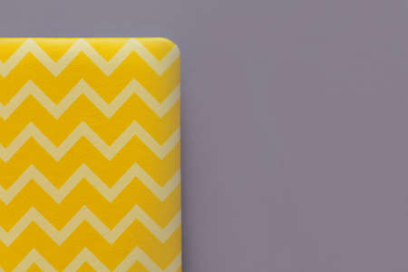 yellow leather diary on a gray background. the concept of planning. Color of the Year 2021...