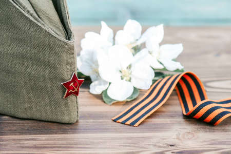 9 may, holiday Victory Day. George ribbon, spring flowers and military cap. copy spaceの写真素材