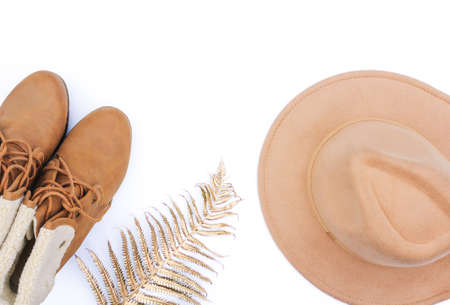 Flat lay autumn and winter fashion photo. Autumn accessories felt hat and beige bootsの写真素材