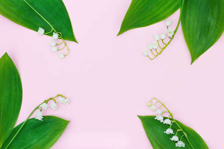 four white lily of the valley flowers on a pink background form a frame for the text.