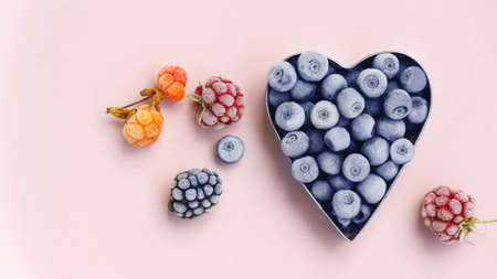 freshly frozen blueberries in the shape of a metal heart, raspberries, blackberries and cloudberries...