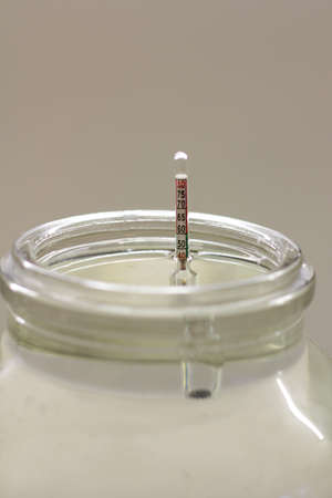 alcohol meter in a glass of moonshine. Wine meter for determining the percentage of alcohol.