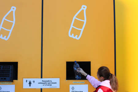 Russia, Saint Petersburg September 03, 2021: a place for sorting waste. a woman throws out garbage...