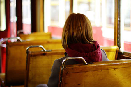 the girl rides in a ground electric public transport. a means of transportation in a big city. girl in transportの写真素材
