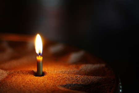Burning candl in a church on a dark background. Details in the orthodox christian churchの写真素材