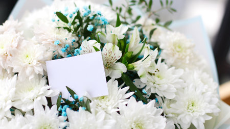 bouquet of different flowers and a empty gift card, place for your textの写真素材