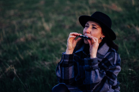 playing the harmonica. a compact musical instrument that is always at handの写真素材