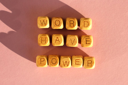 wooden cubes with the inscription world have power on a pink background. selective focus.の写真素材