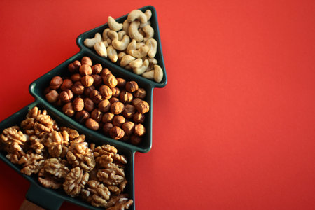 Various snacks for the New Years table in a plate in the shape of a Christmas tree. Top view of a...