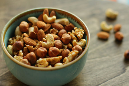 a plate of nuts. a nutritious and healthy snack. A mixture of walnuts, almonds, hazelnuts, cashews. Vegetarian foodの写真素材