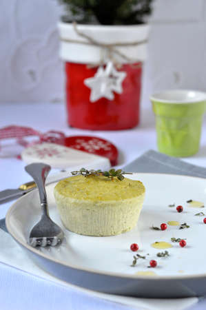 Small salt flan with ricotta, green peas and thyme, decoration  Christmas symbols, white tablecloth, cutlery  の写真素材