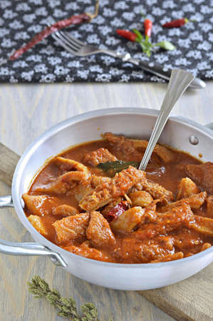 Tripe soup with tomatoes, spicy chili, basil, oregano in a metal pan  Italian food, South Italy の写真素材