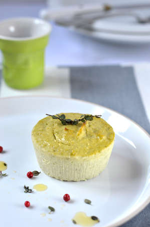 Small salt flan with ricotta, green peas and thyme, decoration  peas pink pepper, a sprig of fresh thyme の写真素材