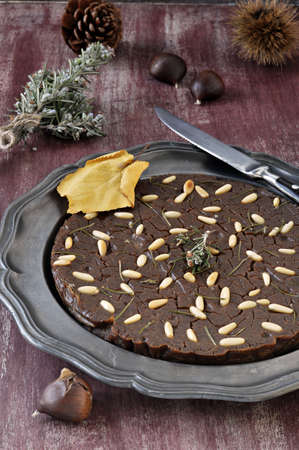 Castagnaccio  Italian dessert  Typical of traditional Tuscan Italian cake made with chestnut flour on a metal plate の写真素材