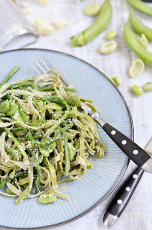 Tagliatelle spinach wild asparagus, fresh beans and Italian cheese  Pecorino Romano   Italian cuisine  Close up の写真素材