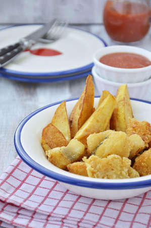 Close up of Fish and Chips  in a white bowl and decorations  ketchup, crockery, cutlery の写真素材