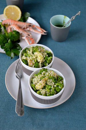 Broccoli salad with pearl barley and Norway lobster Shrimp scampi  の写真素材