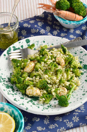 Broccoli salad with pearl barley and Norway lobster Shrimp scampi , decoration  cutlery, salad dressing, shrimp scampi, broccoli  Close-up の写真素材