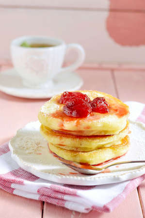 Delicious pancakes with strawberry jam close-up on a saucer on a beautiful antique-style の写真素材