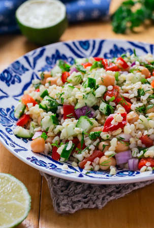 Arabic-style salad of bulgur wheat with vegetablesの写真素材