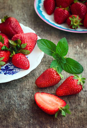 Sweet Red Strawberries with Mint on a Plateの写真素材