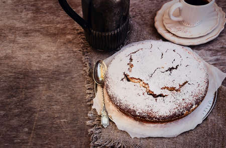 Chocolate Cake in a Vintage Style, accompanied by a Cup of Coffee and Coffee Potの写真素材